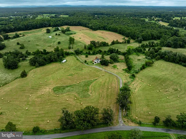 an aerial view of a house with swimming pool and big yard