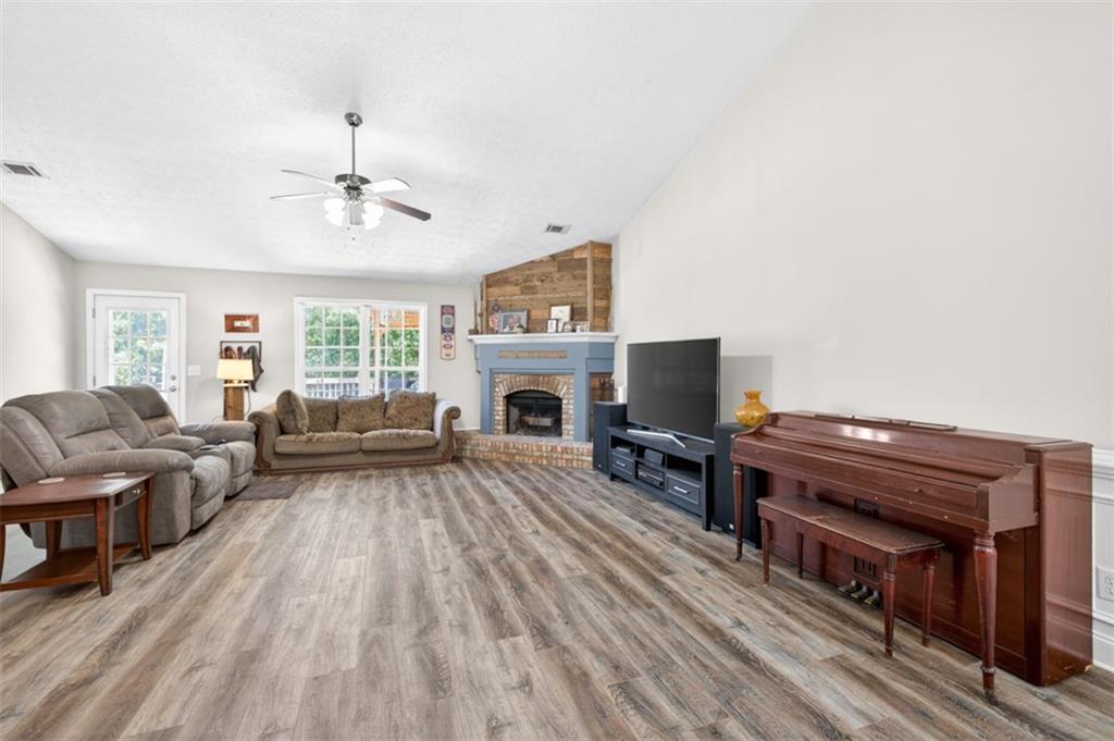 89 Katie Spring Lane Jefferson, GA 30549 - Photo 17 of 63 a living room with furniture fireplace and flat screen tv