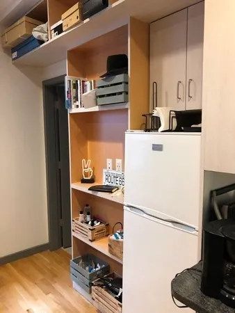 a white refrigerator freezer and a stove sitting inside of a kitchen