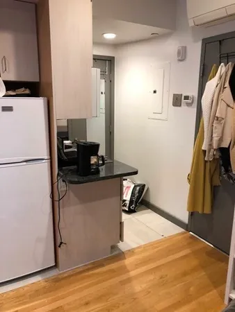 a room with wooden floor and mirror