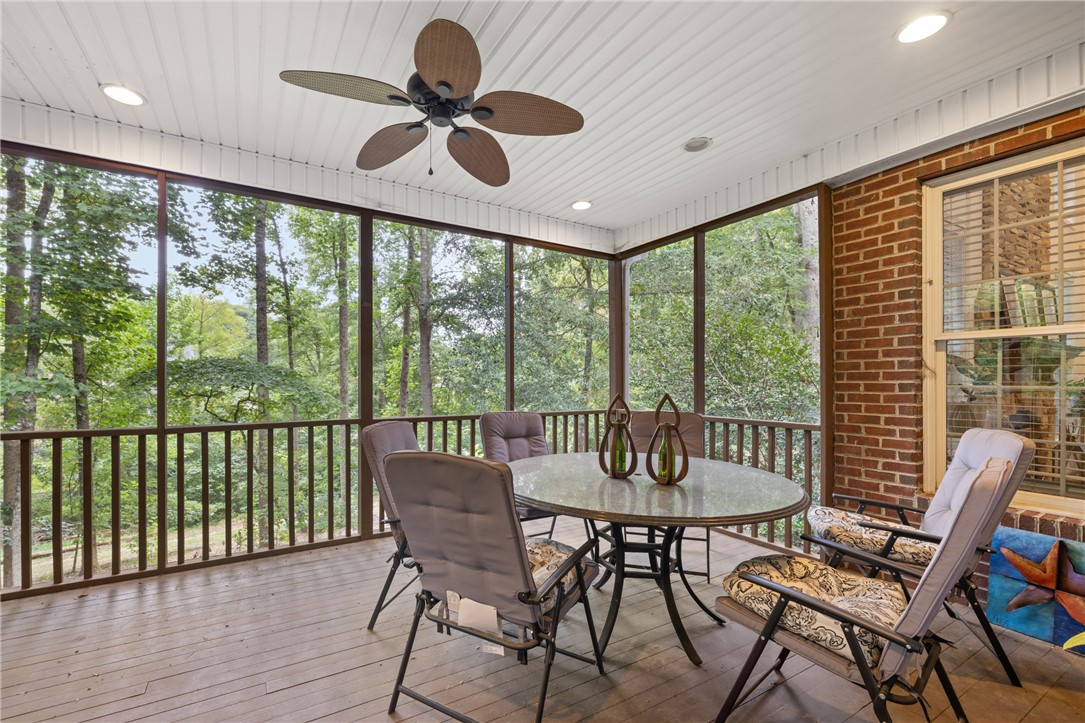 106 Red Maple Way Clemson, SC 29631 - Photo 11 of 49 Wood flooring and a beadboard ceiling define this screened porch overlooking wooded surroundings.