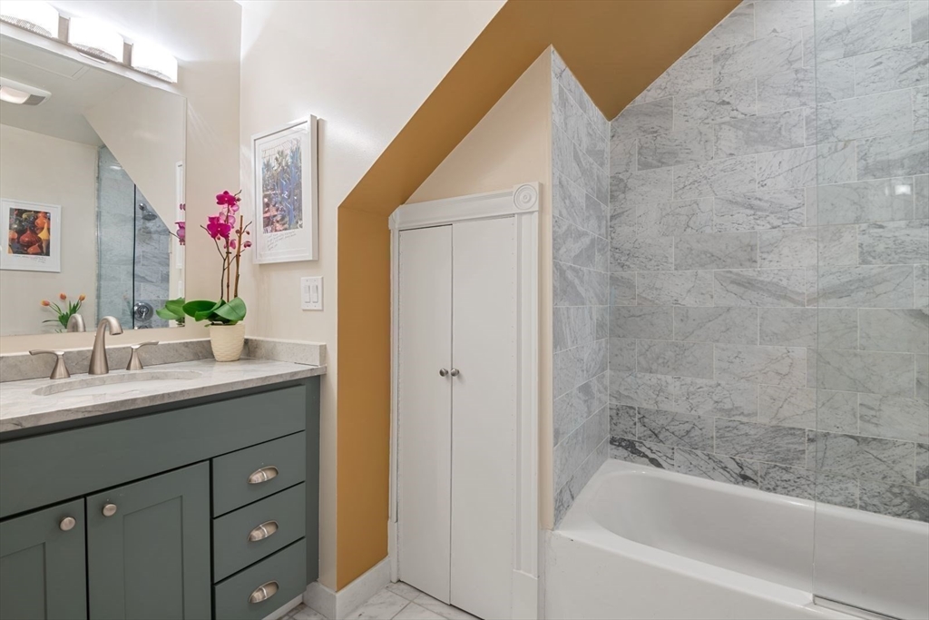 232 West Canton Street, Unit 2 Boston, MA 02116 - Photo 10 of 23 a bathroom with a bathtub sink and mirror