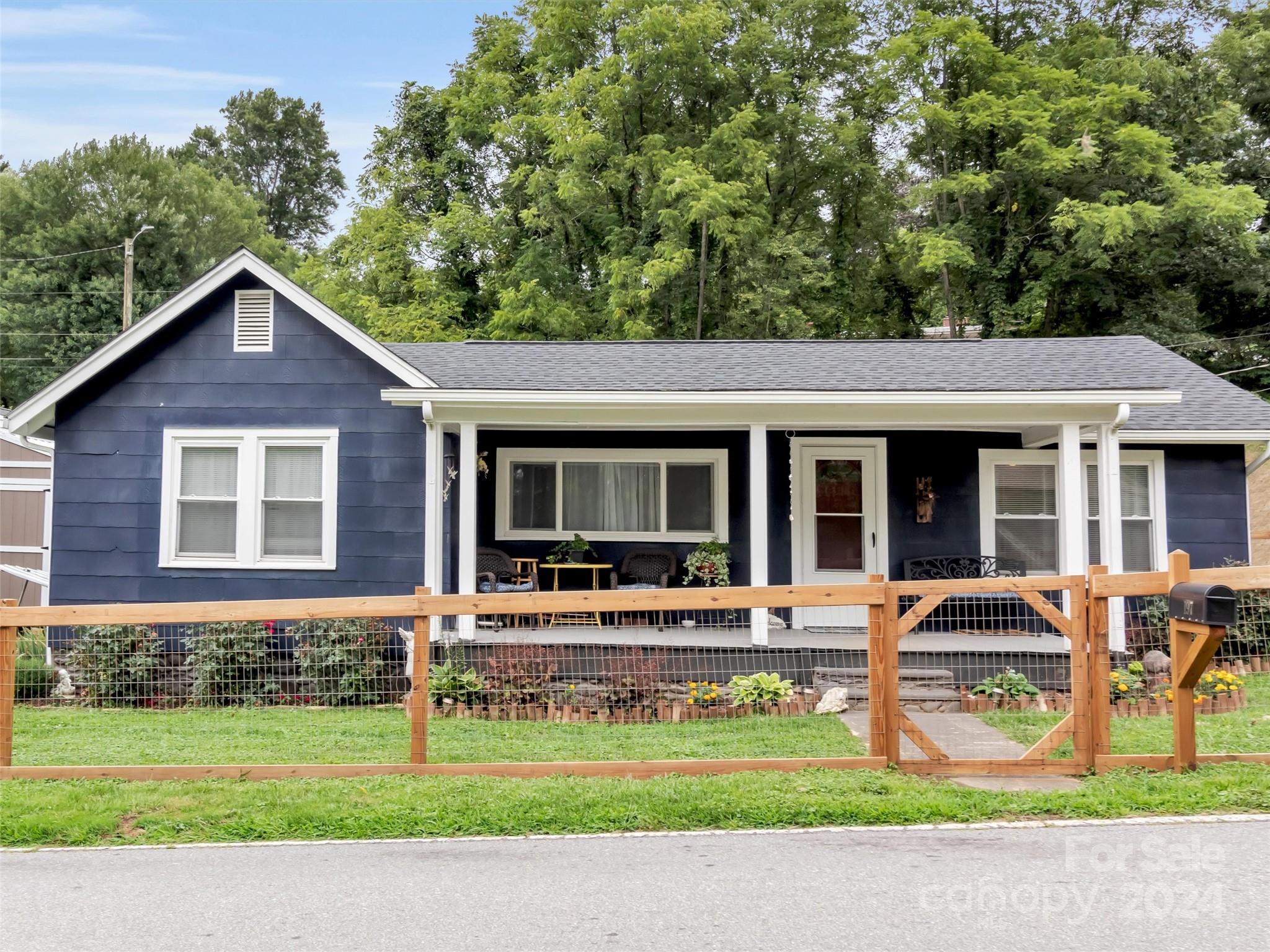a front view of a house with a yard table and chairs