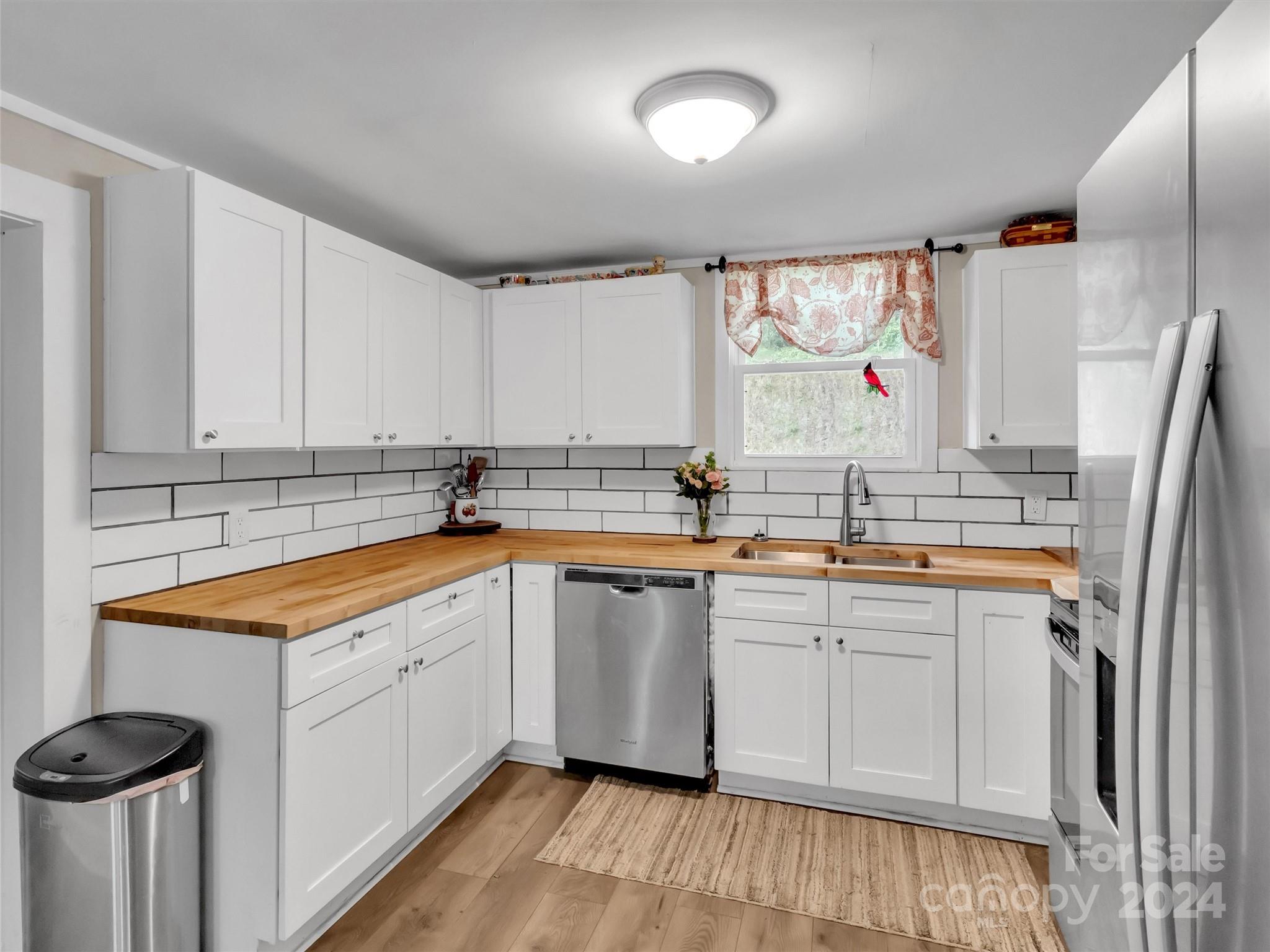 197 Mulberry Street Clyde, NC 28721 - Photo 13 of 20 a kitchen with stainless steel appliances granite countertop a sink and cabinets