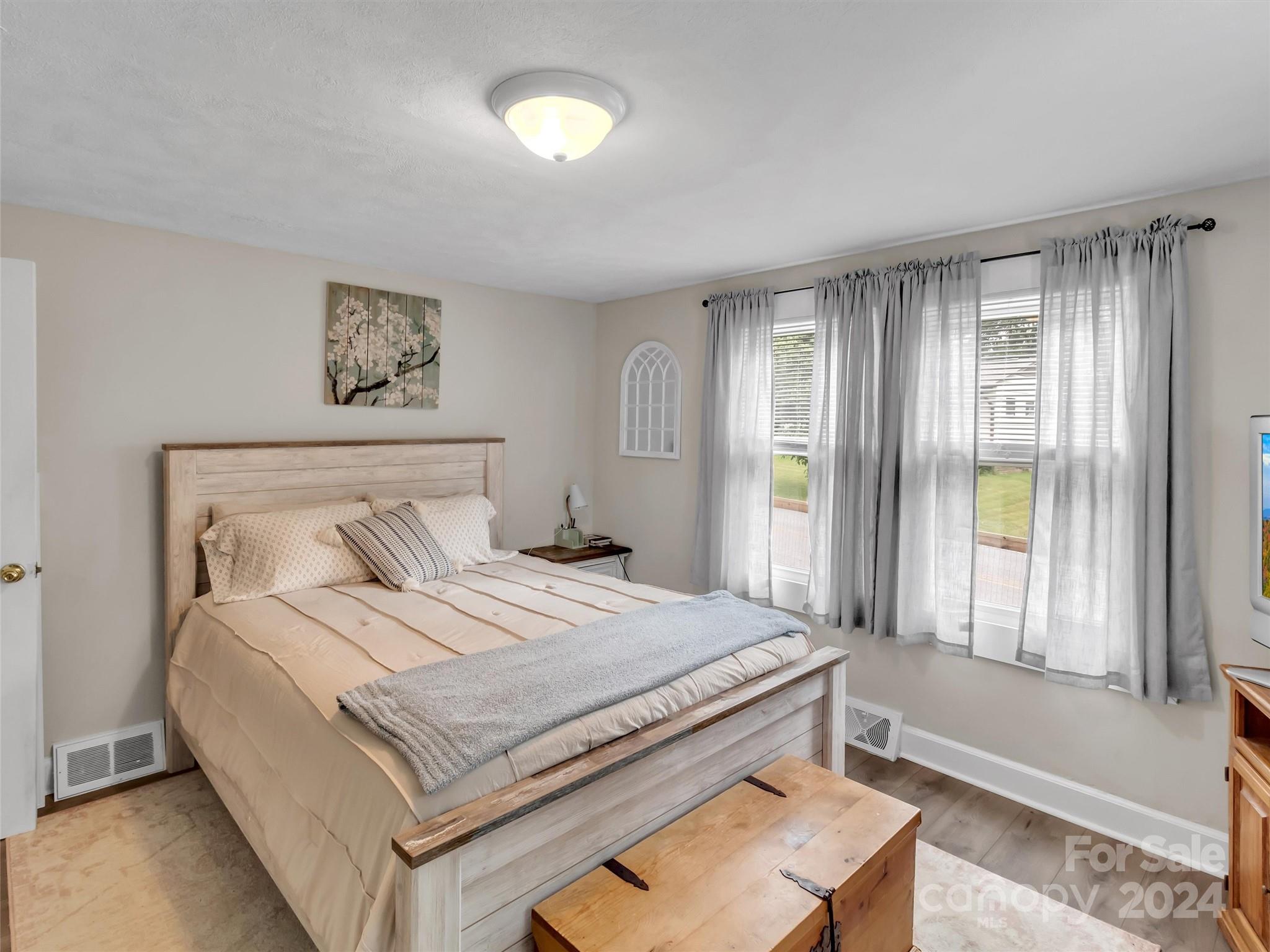 197 Mulberry Street Clyde, NC 28721 - Photo 16 of 20 a bedroom with a bed and a window