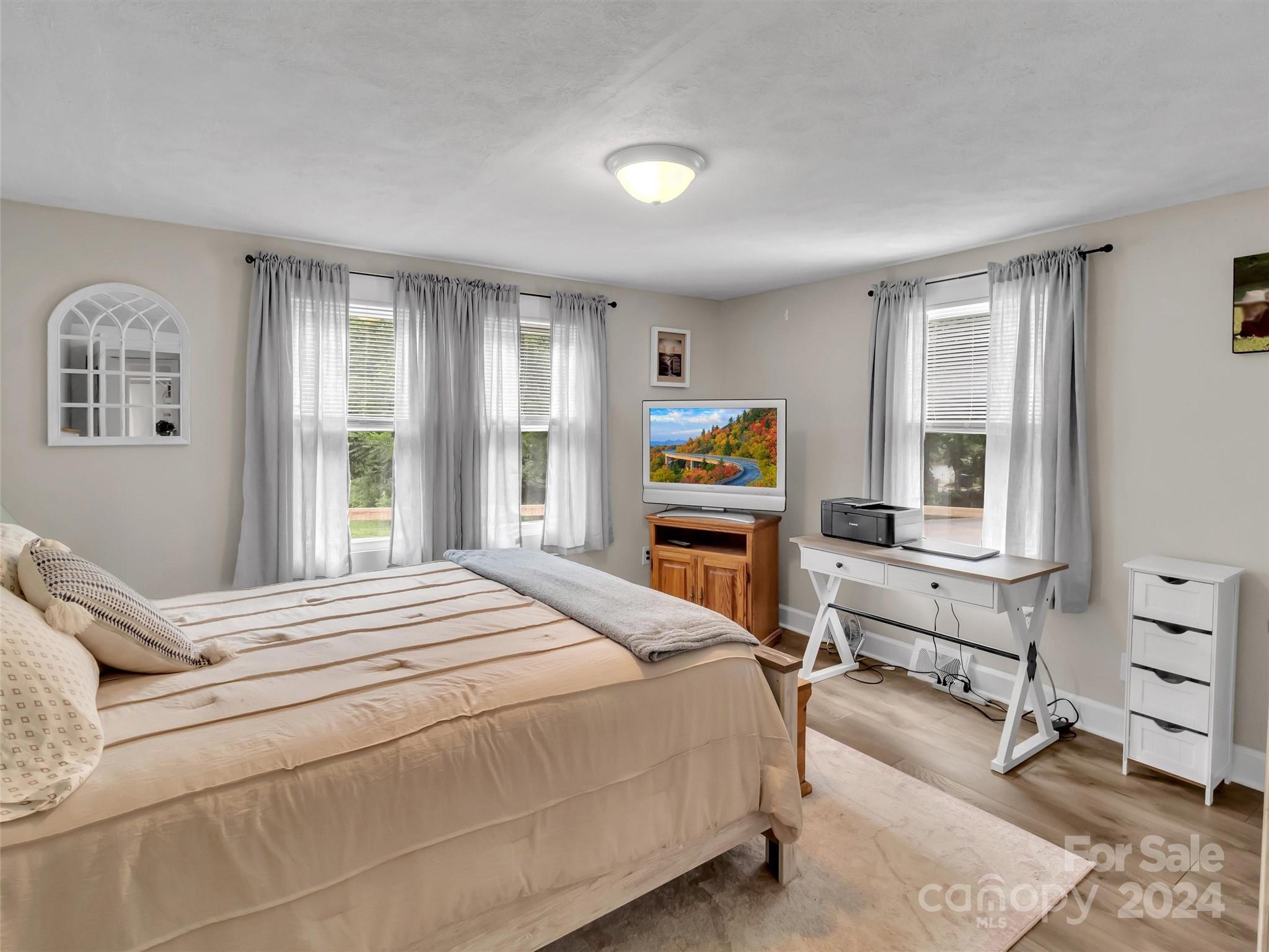 197 Mulberry Street Clyde, NC 28721 - Photo 17 of 20 a bedroom with a bed and a desk