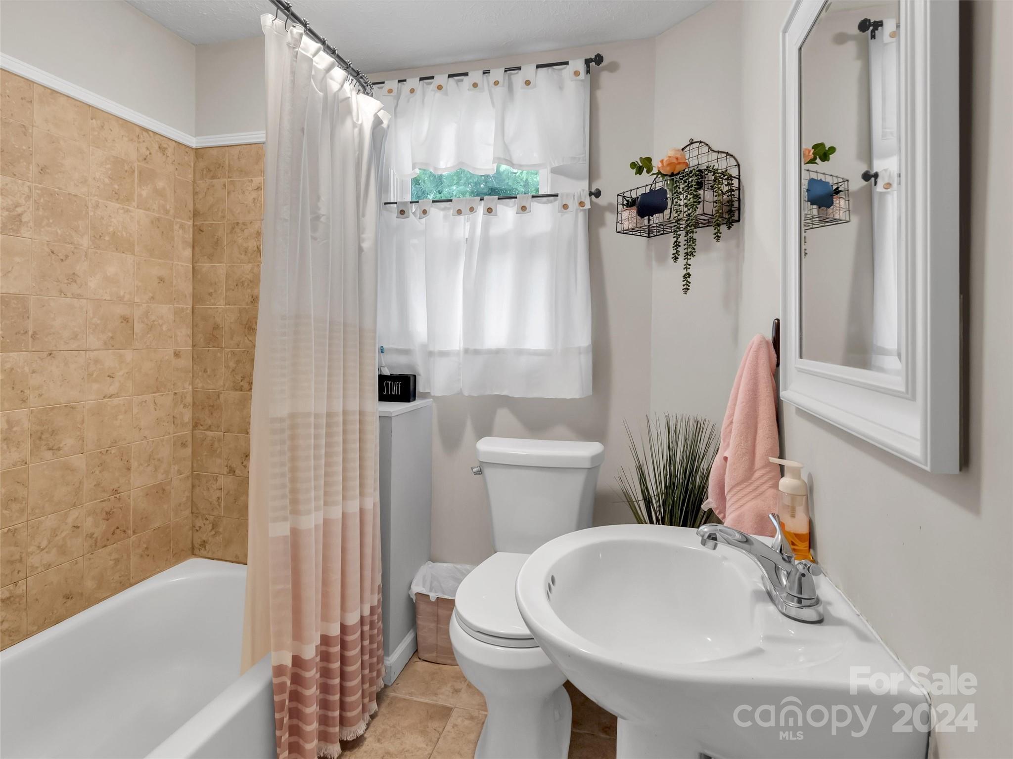 197 Mulberry Street Clyde, NC 28721 - Photo 18 of 20 a bathroom with a sink toilet and shower