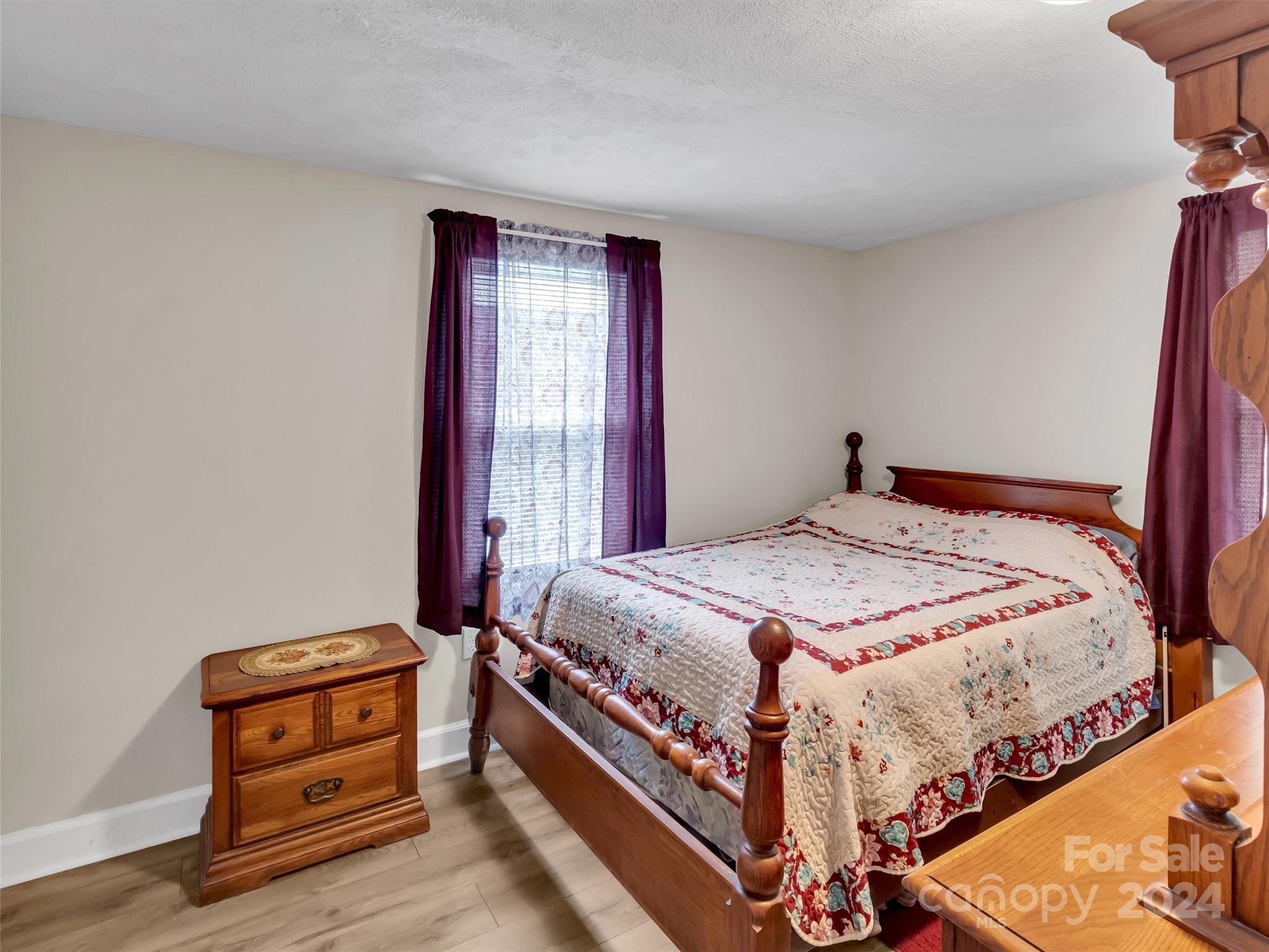 197 Mulberry Street Clyde, NC 28721 - Photo 19 of 20 a bedroom with a bed and a window