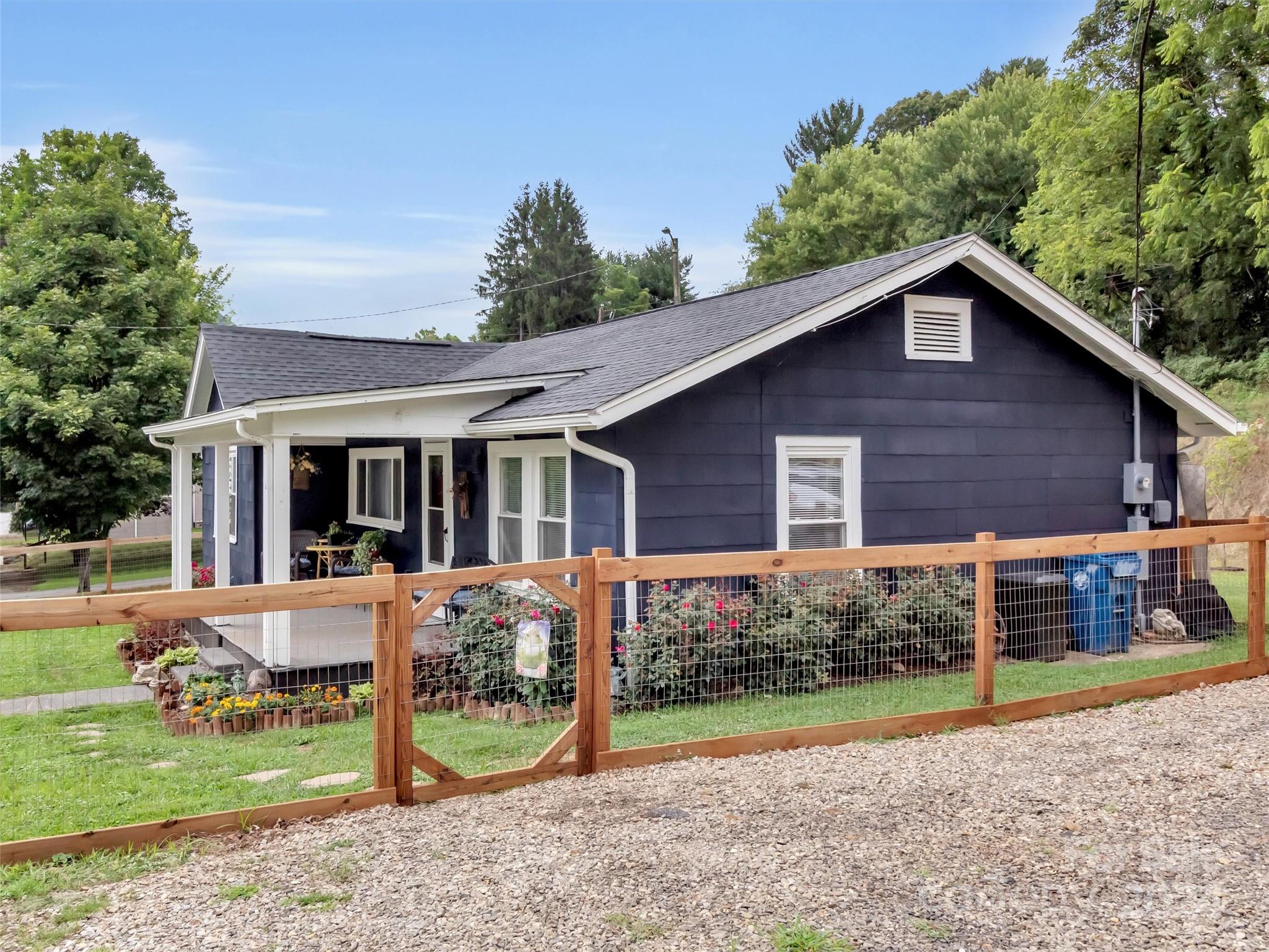197 Mulberry Street Clyde, NC 28721 - Photo 3 of 20 a view of a house with a yard and plants
