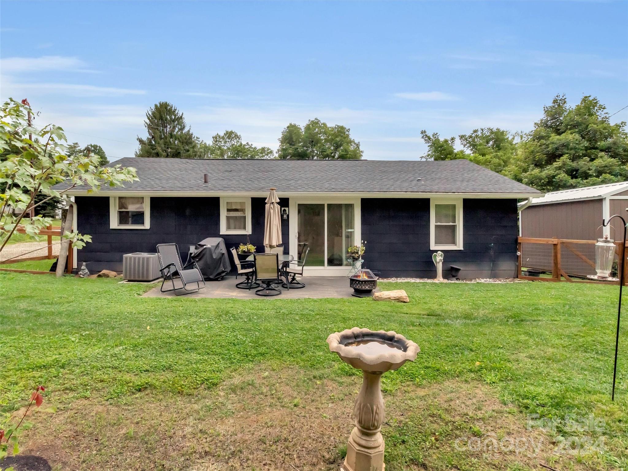 197 Mulberry Street Clyde, NC 28721 - Photo 4 of 20 a front view of a house with patio garden and patio