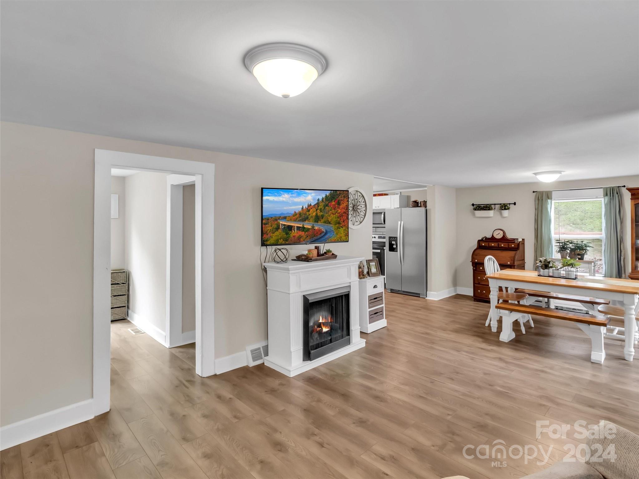 197 Mulberry Street Clyde, NC 28721 - Photo 8 of 20 a living room with furniture and a fireplace