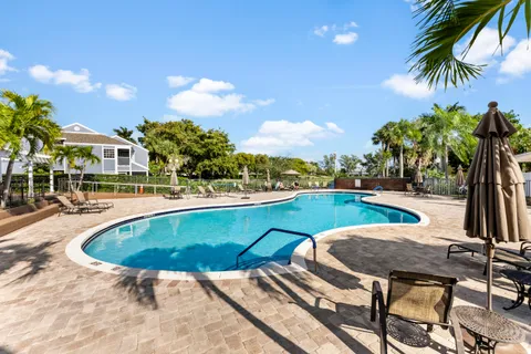a swimming pool with outdoor seating and yard