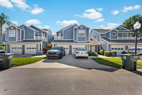 a couple of cars parked in front of a house