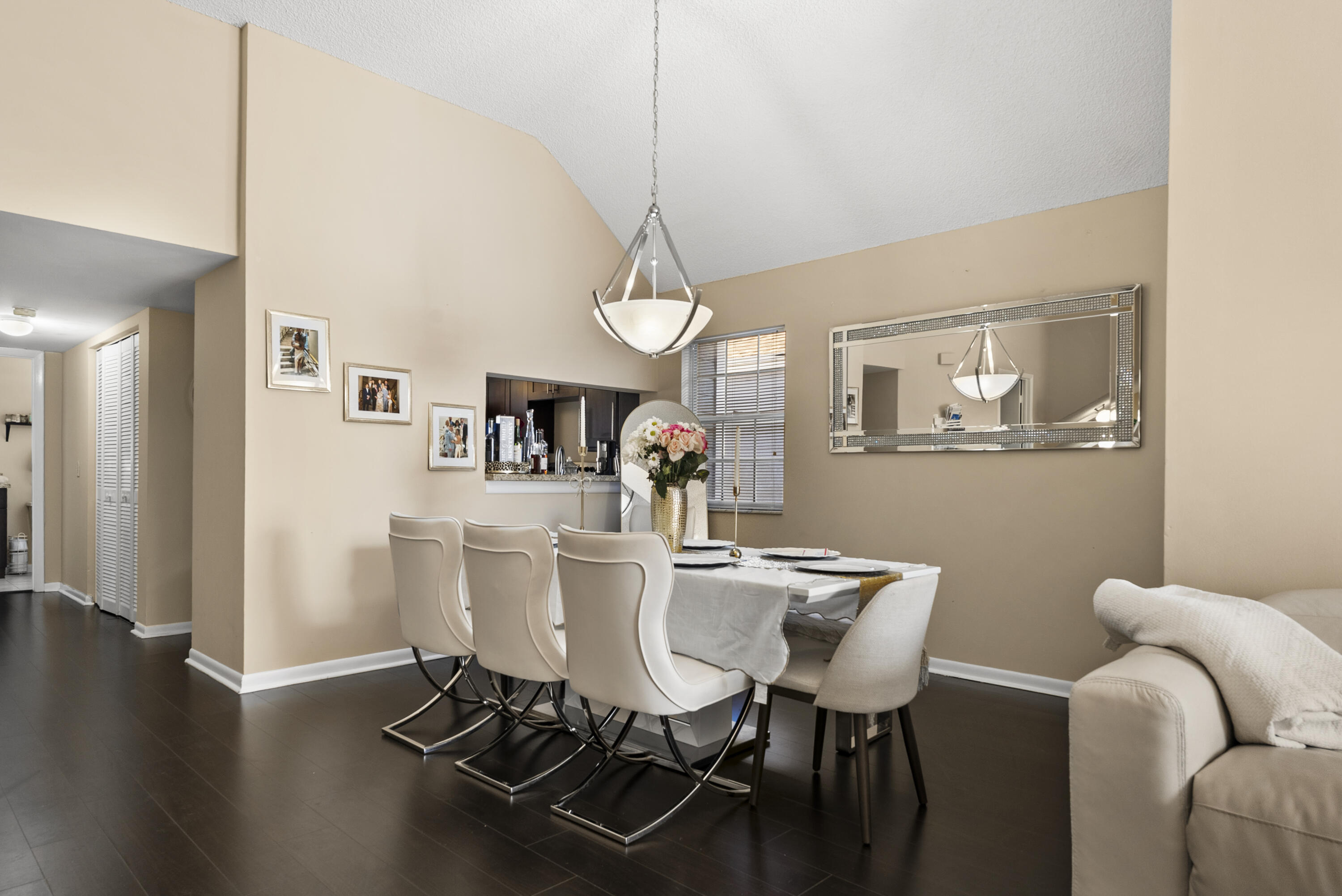 5359 Buckhead Circle, Unit 2031 Boca Raton, FL 33431 - Photo 16 of 25 a view of a dining room with furniture wooden floor and chandelier