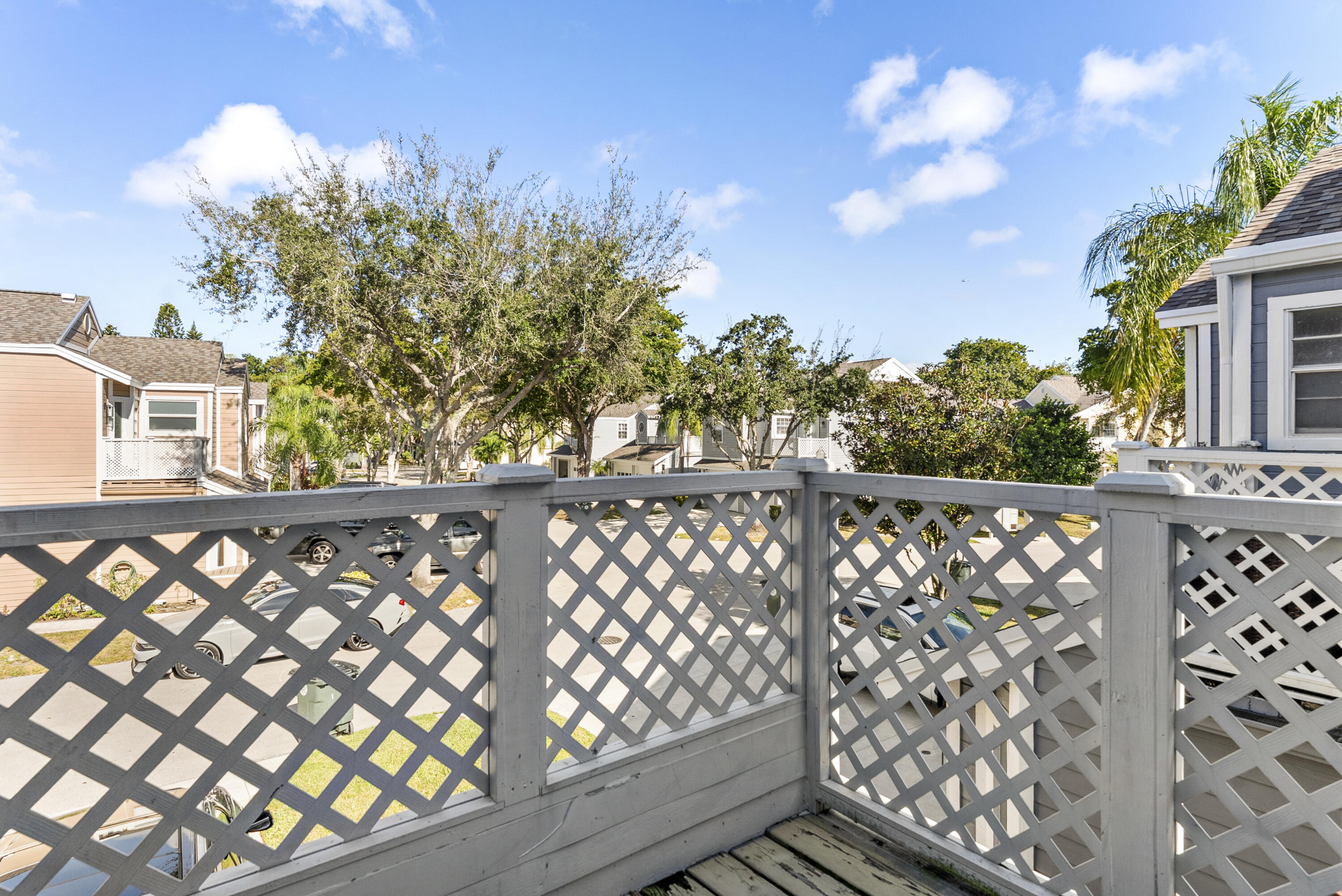5359 Buckhead Circle, Unit 2031 Boca Raton, FL 33431 - Photo 20 of 27 a view of a wooden fence and trees