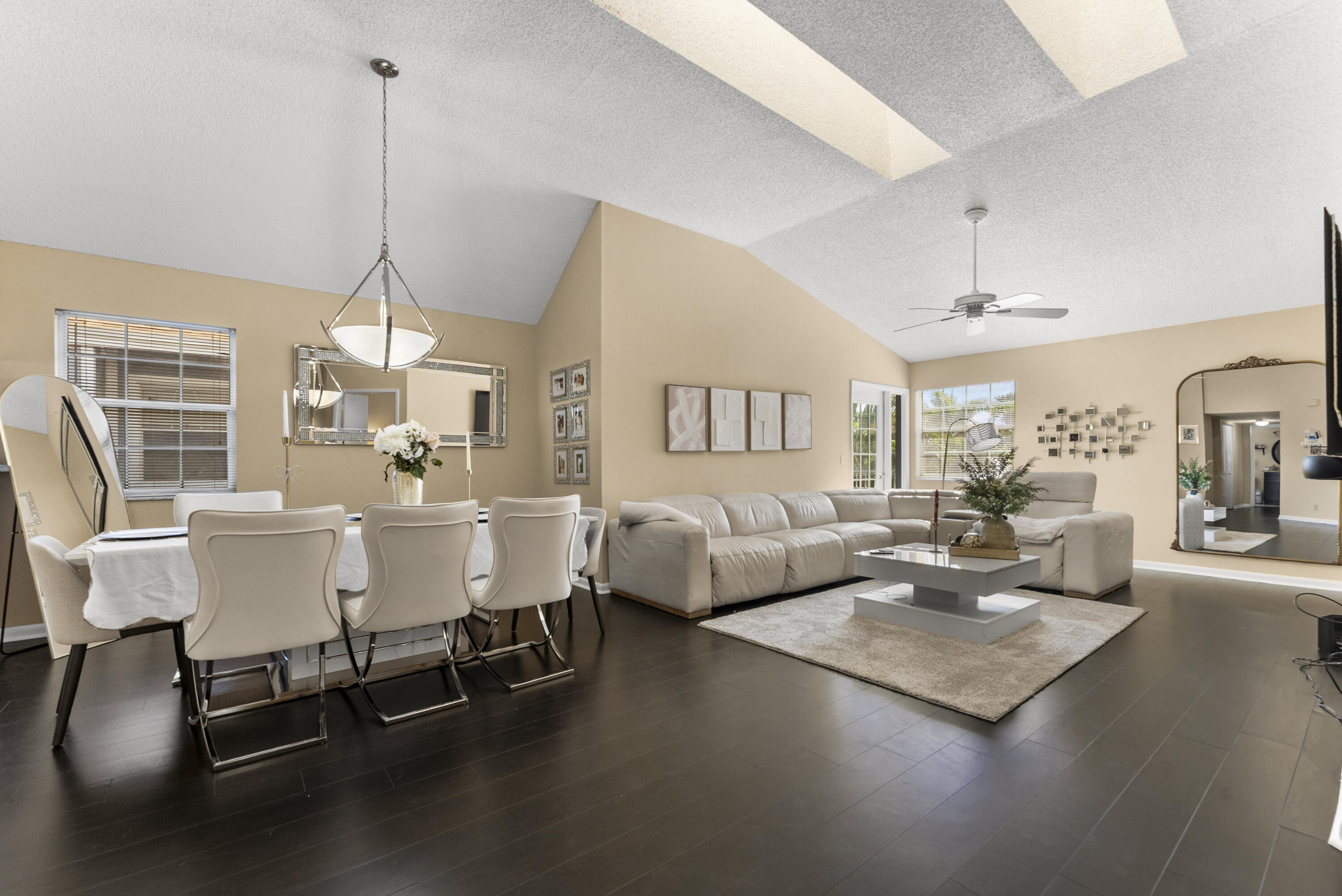 5359 Buckhead Circle, Unit 2031 Boca Raton, FL 33431 - Photo 2 of 27 a living room with couches a coffee table and chairs with wooden floor