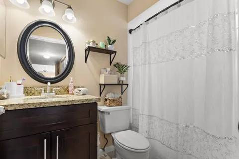 a bathroom with a toilet a sink and a mirror