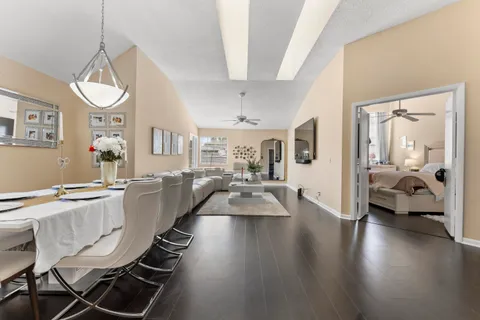 a view of a dining room with furniture wooden floor and a chandelier