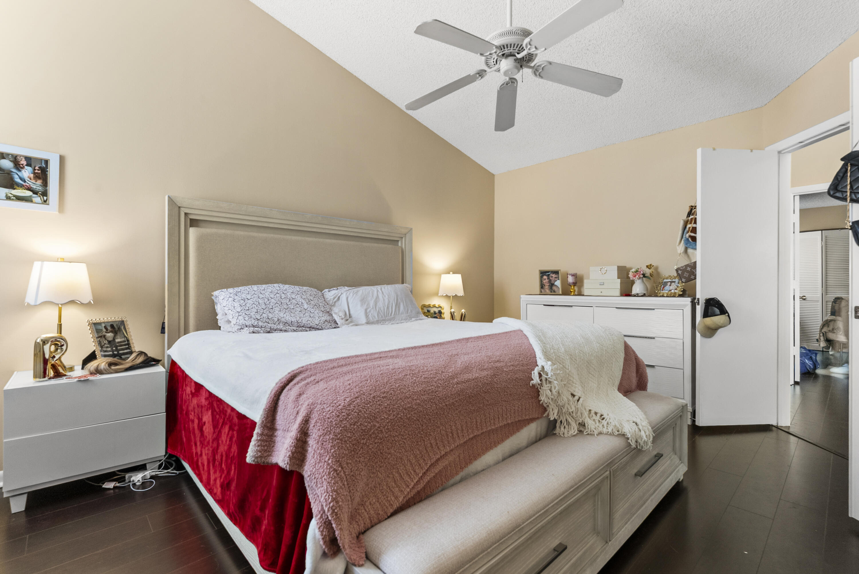 5359 Buckhead Circle, Unit 2031 Boca Raton, FL 33431 - Photo 4 of 27 a bedroom with a bed and a chandelier