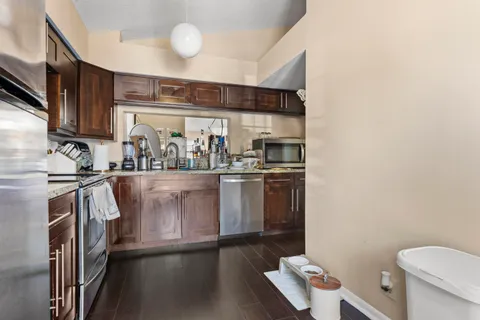 a kitchen with a sink appliances and cabinets