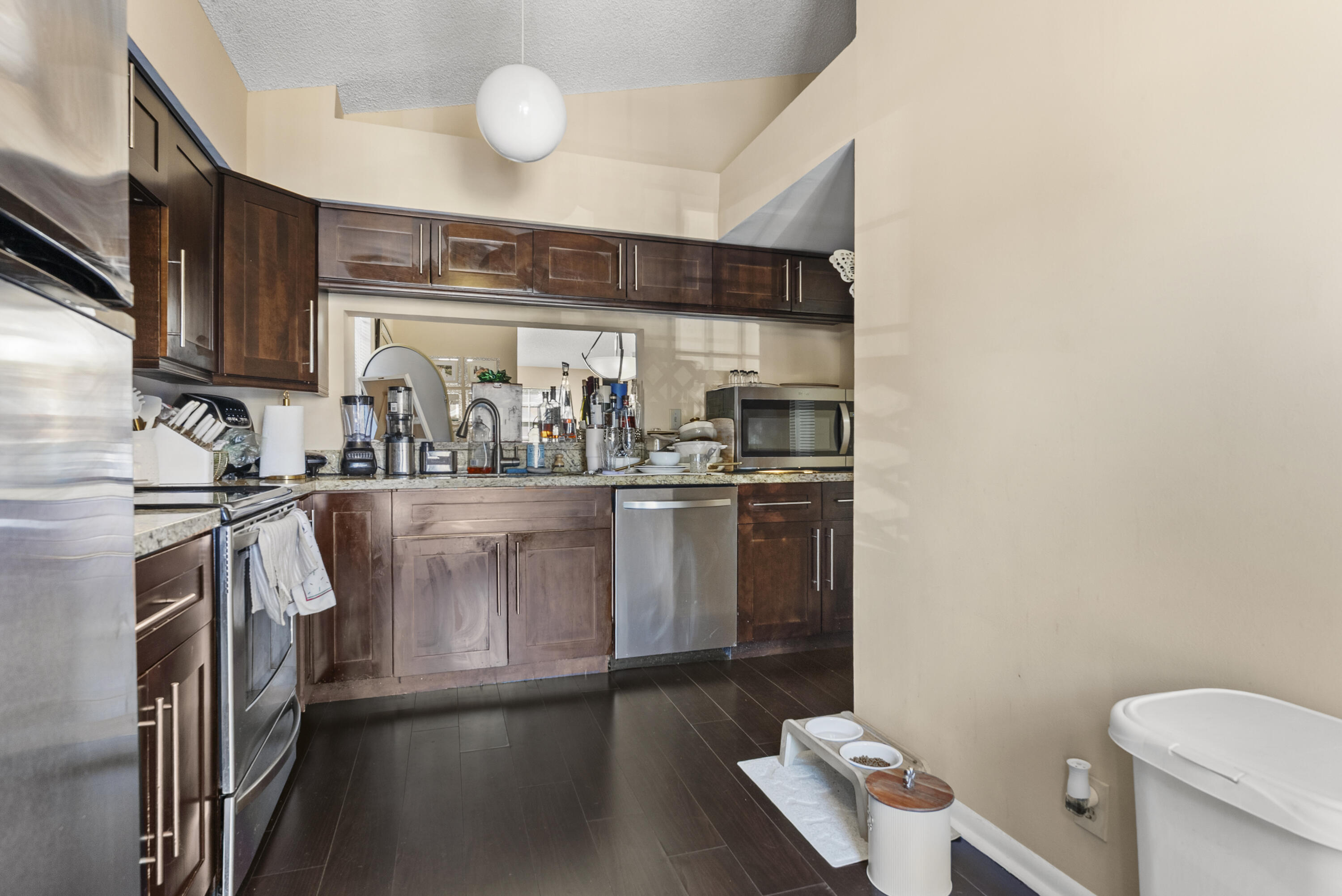 5359 Buckhead Circle, Unit 2031 Boca Raton, FL 33431 - Photo 5 of 27 a kitchen with a sink appliances and cabinets