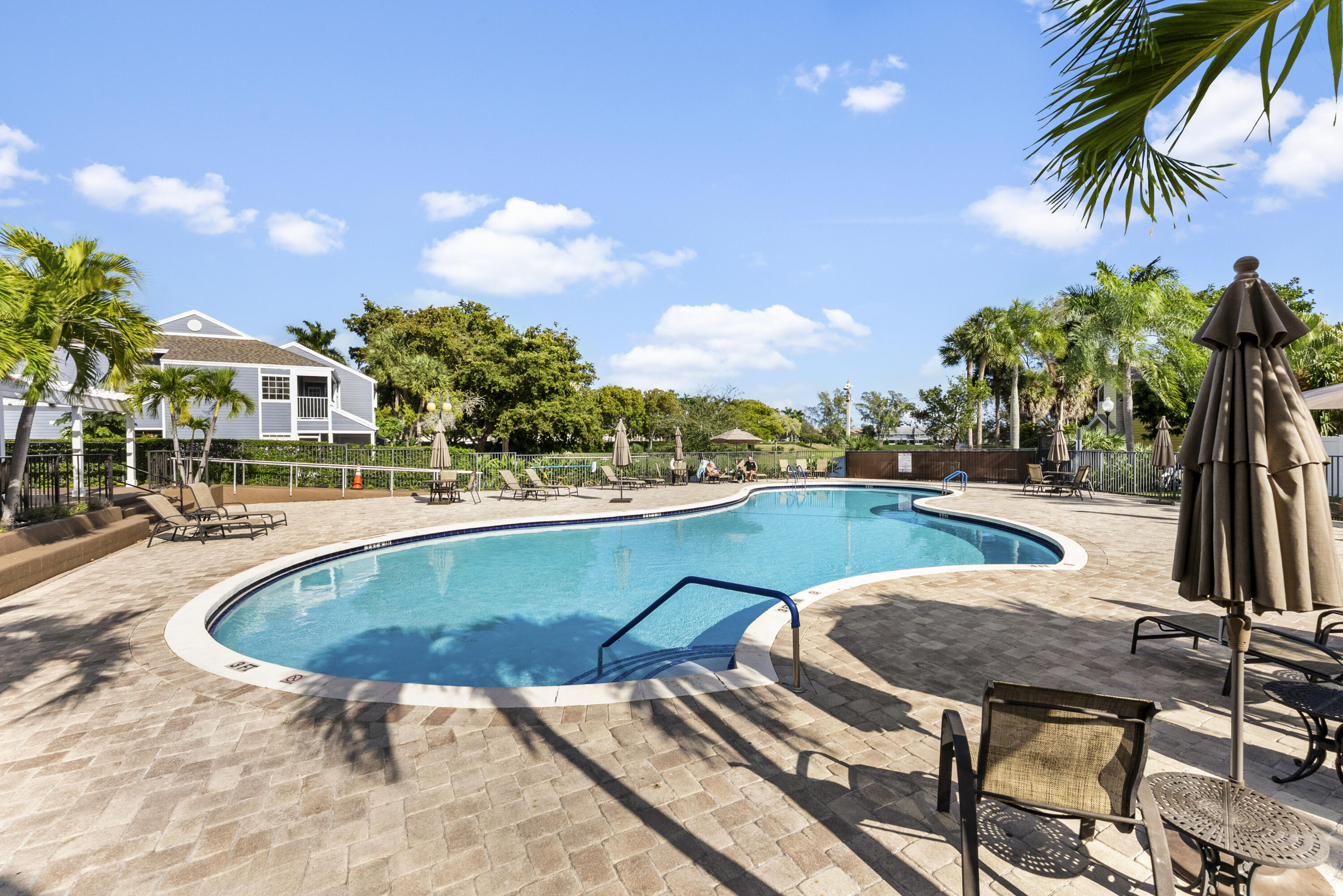 5359 Buckhead Circle, Unit 2031 Boca Raton, FL 33431 - Photo 9 of 25 a swimming pool with outdoor seating and yard