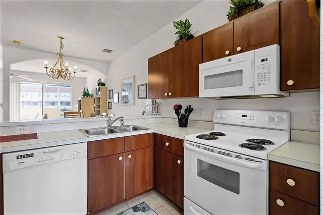 a kitchen with a sink stove top oven and microwave
