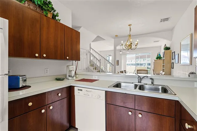 a kitchen with a sink cabinets and window