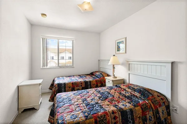 a bedroom with two beds and a window
