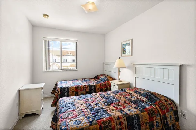 a bedroom with two beds and a window