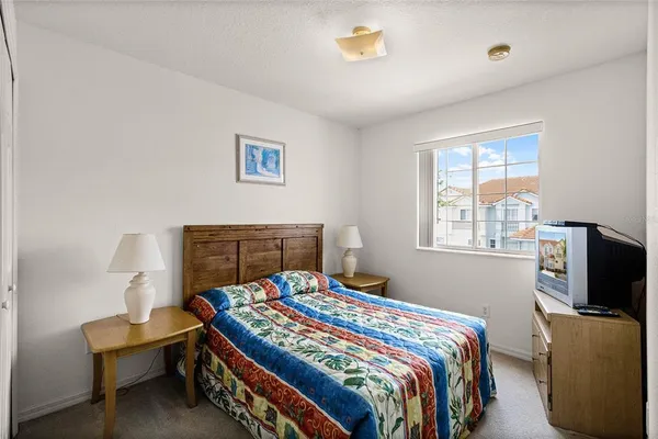 a bedroom with a bed and a flat screen tv