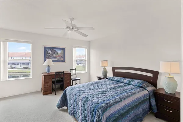 a bedroom with a bed and dresser with mirror