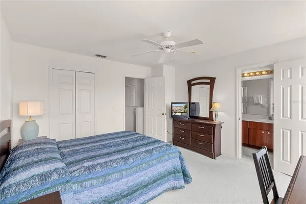 a bedroom with a bed and a dresser