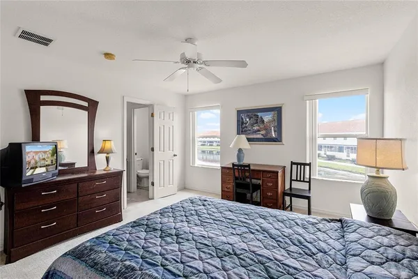 a bedroom with a bed and a dresser in it