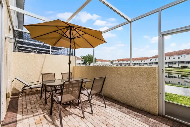 a view of a terrace with furniture and umbrella