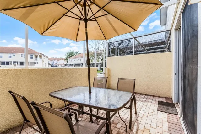 a view of balcony with furniture and umbrella
