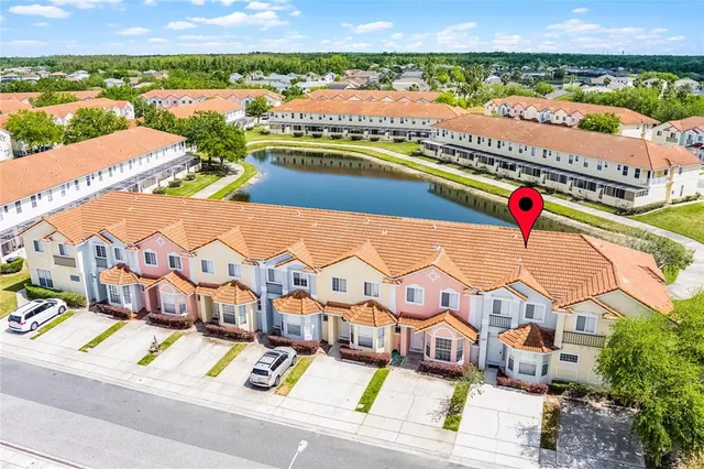 an aerial view of residential houses with outdoor space and river