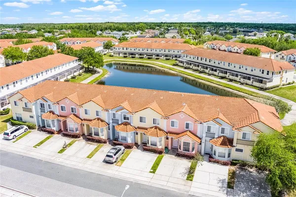 an aerial view of residential houses with outdoor space and river