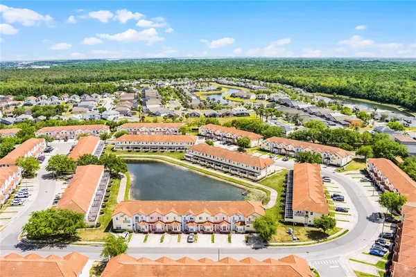 an aerial view of residential houses with outdoor space and ocean view