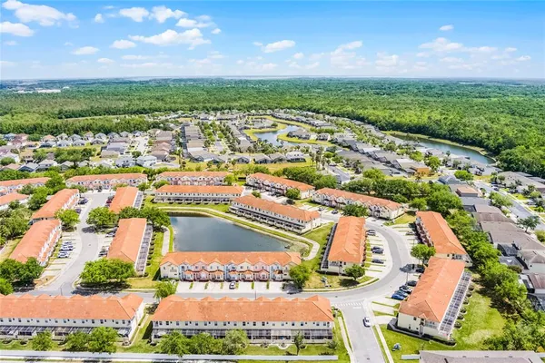 an aerial view of residential houses with outdoor space and river