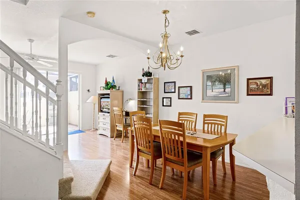 a view of a dining room with furniture wooden floor and a chandelier