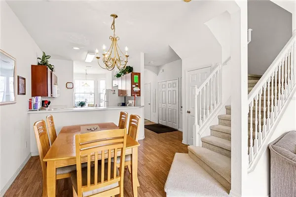 a view of a dining room with furniture and a chandelier
