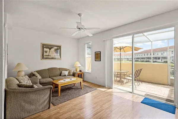 a living room with furniture and a floor to ceiling window