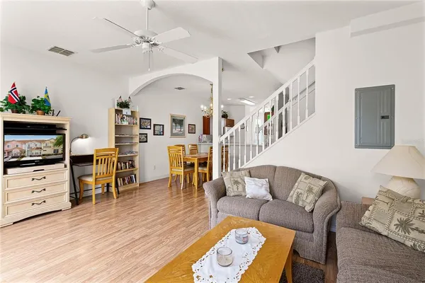 a living room with furniture and wooden floor