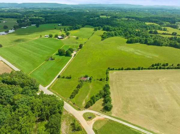 a view of a green field with sitting space
