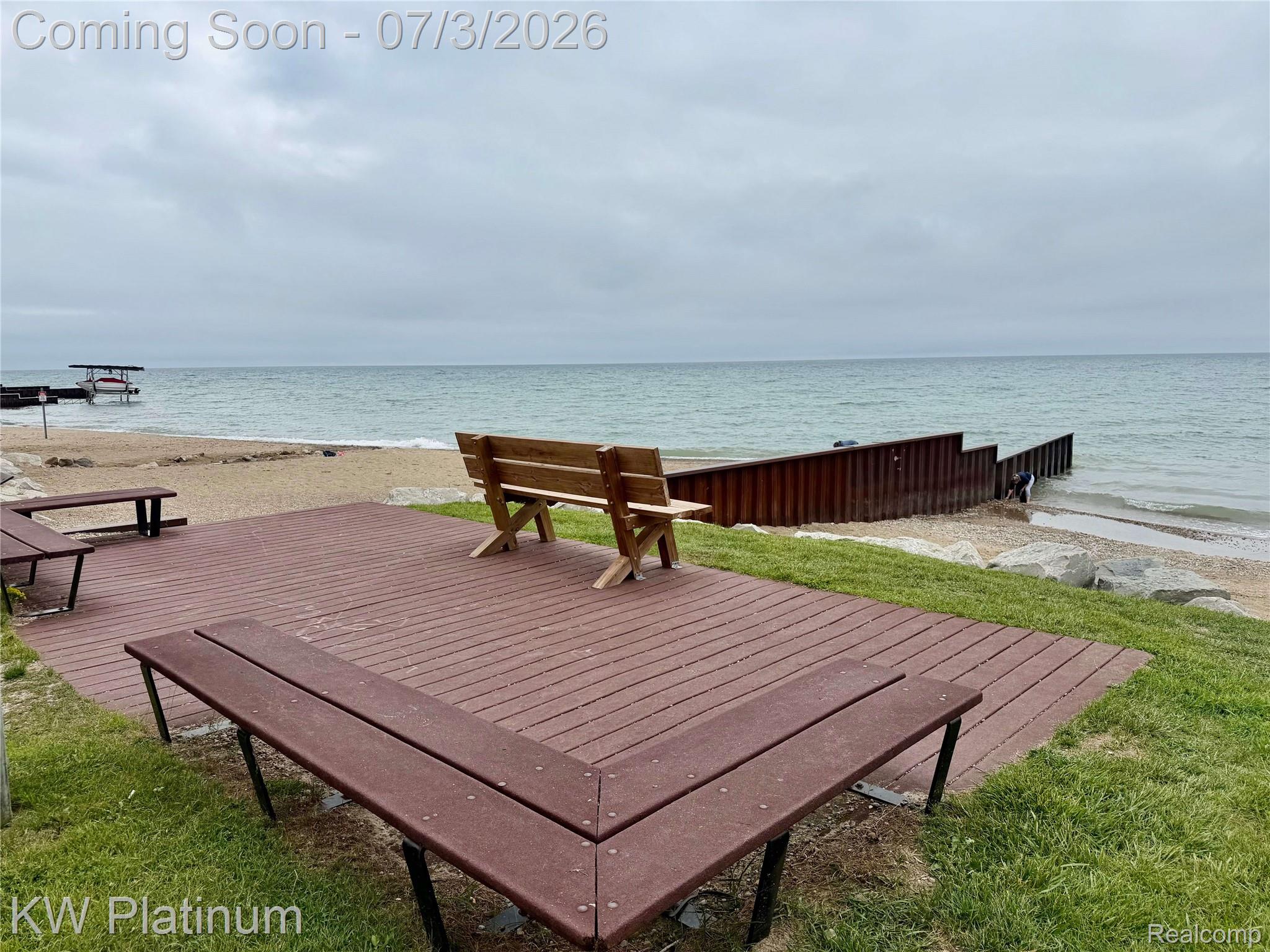 7955 Lakeshore Road Fort Gratiot, MI 48059 - Photo 26 of 30 Expansive composite deck with integrated seating and bench, offering direct access to a sandy beach