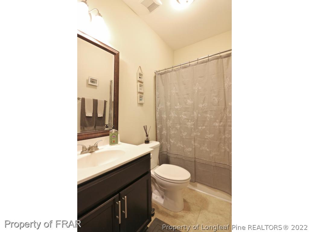 740 Sun Road Aberdeen, NC 28315 - Photo 14 of 36 a bathroom with a sink a toilet and shower
