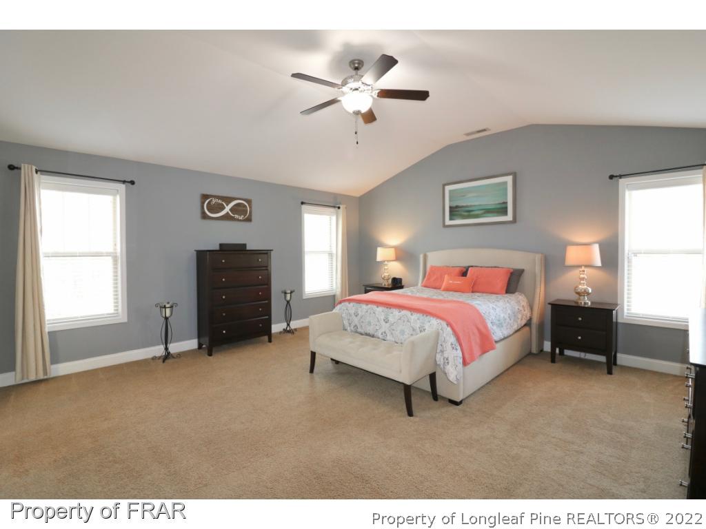 740 Sun Road Aberdeen, NC 28315 - Photo 18 of 36 a spacious bedroom with a bed and a ceiling fan