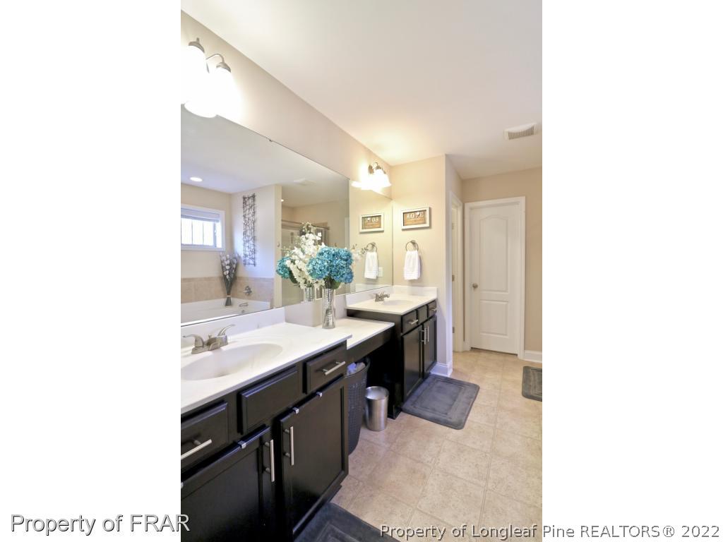 740 Sun Road Aberdeen, NC 28315 - Photo 21 of 36 a bathroom with a sink and a mirror