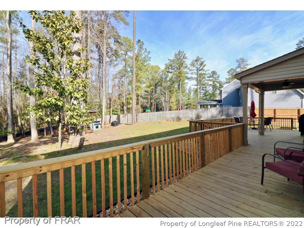 740 Sun Road Aberdeen, NC 28315 - Photo 31 of 36 a view of balcony with wooden floor and outdoor seating